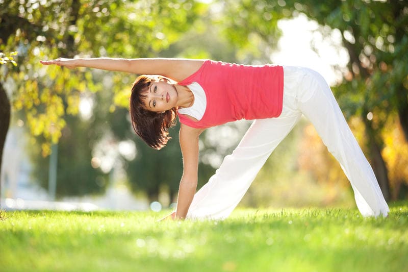 Woman stretching outdoors during morning exercise routine
